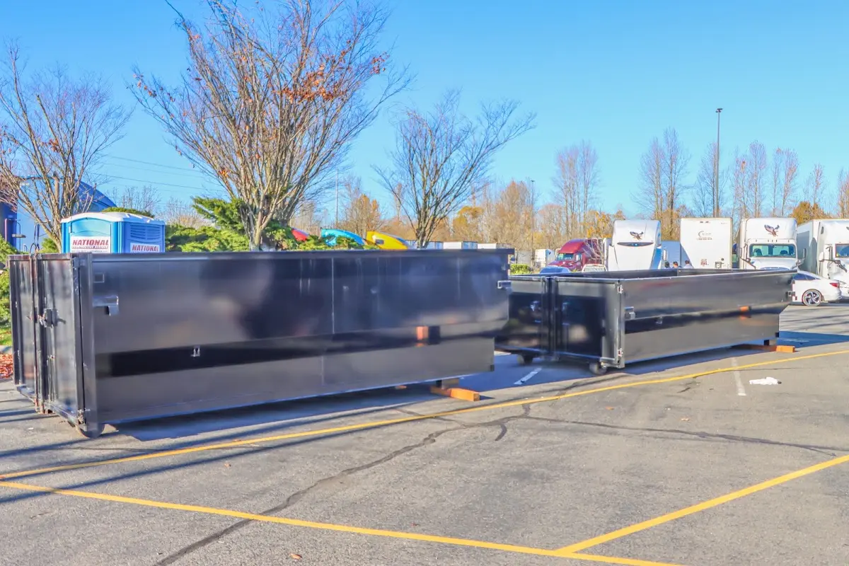 Professional dumpster rental service with roll-off container on residential driveway in Centennial
